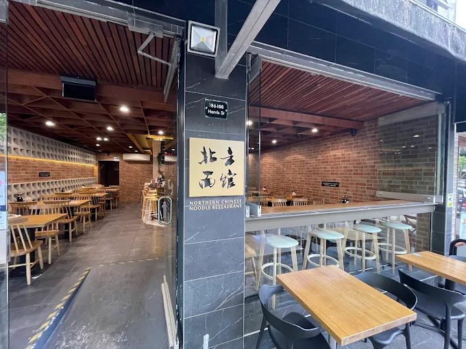 Brick-lined interior dining room with window bar overlooking Harris Street
